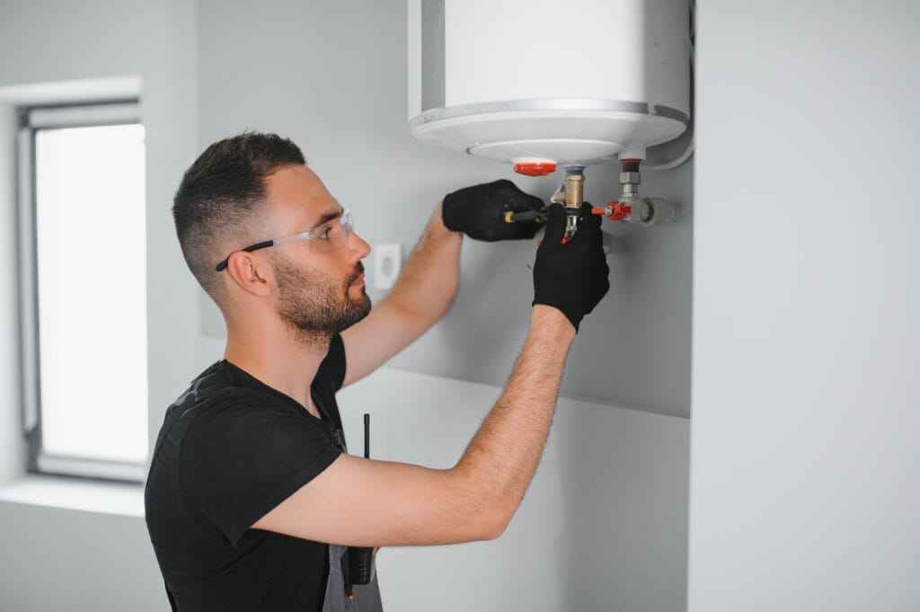 Technician performing water heater maintenance in Panama City Beach