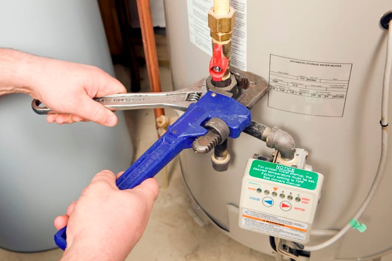 Plumber repairing a water heater valve in Panama City Beach